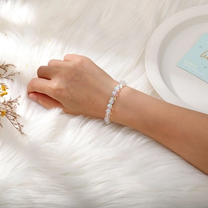 Close-up of iridescent beaded bracelet with pavé silver bead worn on wrist