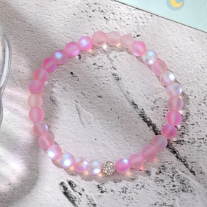 Detailed view of pink aurora frosted crystal bracelet with a zircon pave spacer bead