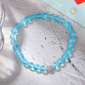 Detail of blue frosted moonstone stretch bracelet with sparkling zircon pave ball bead
