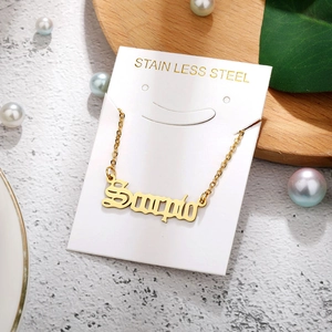 Macro shot of Scorpio constellation gold necklace with stainless steel jewelry detail