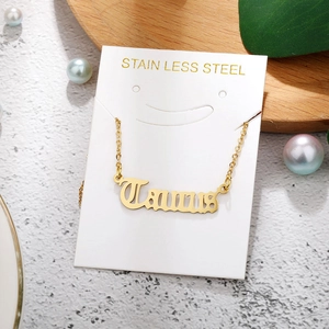 Golden Taurus zodiac pendant on a stainless steel chain with decorative pearls