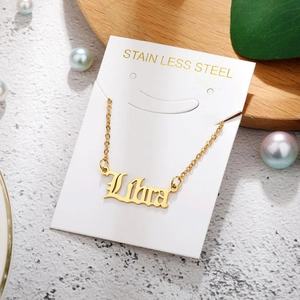 Macro shot of custom Liora name necklace in gold finish on stainless steel O-chain