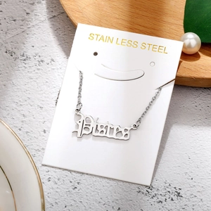 Macro shot of silver stainless steel Pisces zodiac pendant on elegant display card
