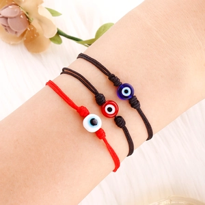 Detailansicht der gewebten Evil Eye Armbänder in Rot und Schwarz mit bunten Glasperlen