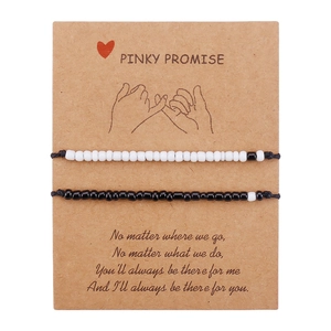 Detail of Pinky Promise card with black and white beaded couple friendship bracelets