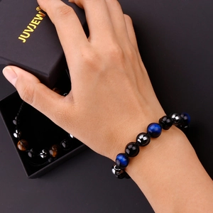 Detail of natural stone beaded bracelet for men in a premium black branded gift box
