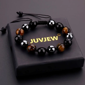 Detail of natural tiger eye and obsidian beaded bracelet on a black jewelry gift box