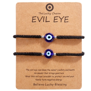Two-piece braided Evil Eye bracelet set with protective beads on brown display card