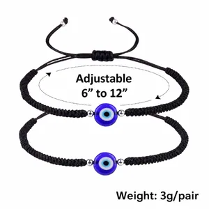 Adjustable braided Evil Eye bracelet set with blue beads and silver spacers on white base