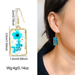 Gold rectangular drop earrings with blue dried flowers and gold foil details for women