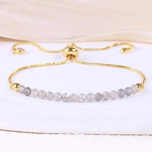 Detail of adjustable gold snake chain bracelet with 4mm faceted grey natural stone beads