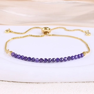 Close-up of faceted purple beads and adjustable gold plated box chain with slider clasp