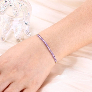 Detail of 3mm purple faceted crystal beaded bracelet with gold plated clasp on wrist