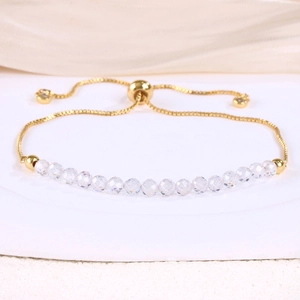 Detail of adjustable gold-plated snake chain bracelet with transparent crystal beads