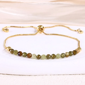 Detail view of adjustable gold snake chain bracelet with 4mm natural stone crystal beads