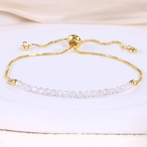 Detail of adjustable gold-plated chain with multi-faceted transparent crystal beads