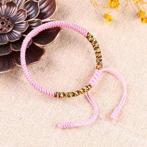 Detail von rosa handgefertigtem geflochtenem Armband mit farbigem Seidenfaden und Knoten