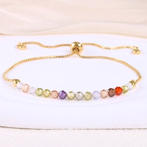 Detail of colorful faceted crystal beads on an adjustable gold snake chain bracelet