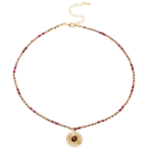 Detail of colorful beaded necklace featuring a golden sun pendant with tiger eye stone