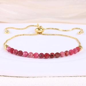 Detail view of pink natural stone beads and adjustable gold chain bracelet