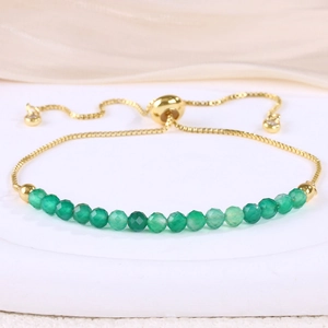 Detail of adjustable gold slider chain bracelet with faceted green gemstone beads