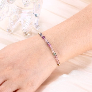 Detailed shot of 4mm natural colorful stone beads and crystals on a gold snake chain bracelet