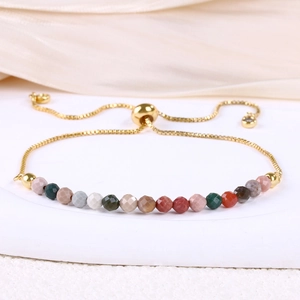Detail of adjustable gold snake chain bracelet with multi-color 4mm faceted natural stones