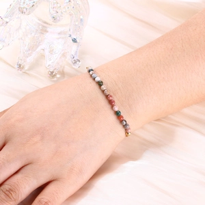 Detail of colorful faceted crystal beads and gold spacers on a women's beaded bracelet