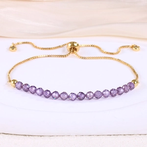 Detailed macro view of gold-plated bolo bracelet with 18 faceted purple crystal beads
