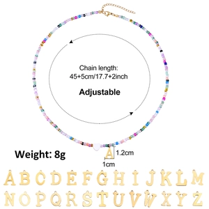 Detail of colorful bead necklace showing 26 gold initial pendants and sizing specifications