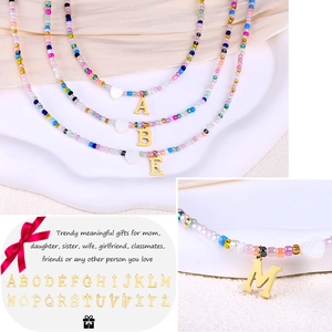 Colorful bead necklace with golden initial pendant and heart charm for women