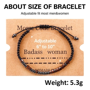 Detail of adjustable black woven Morse code bracelet with dark wood beads and sizing info