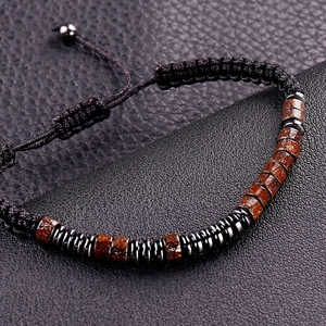 Close-up of vintage Morse code beaded bracelet with adjustable woven strap and metal spacers