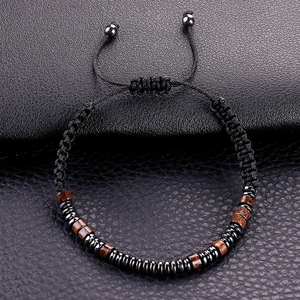 Detail of hand-woven black cord bracelet with wooden beads and adjustable sliding knot