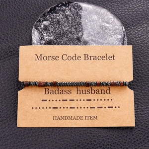 Detail of handmade Morse code bracelet for husband on vintage kraft card with obsidian beads