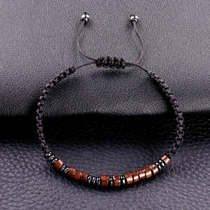 Detail of Morse code bracelet with black cord, wood beads and adjustable slider