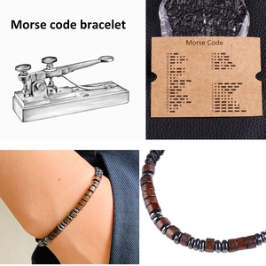 Detail view of Morse code bracelet featuring wooden beads and an alphabet card for reference