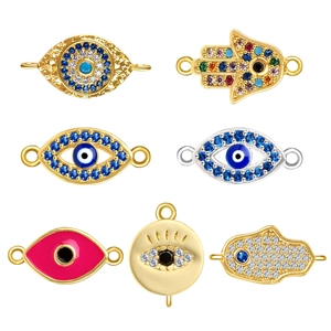 Selection of Evil Eye and Hamsa Hand charms in gold finish with colorful zircon stones