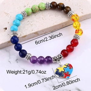 Detail view of colorful natural stone beads bracelet with a puzzle heart pendant charm