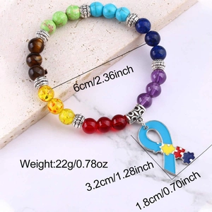 Detail of colorful stone bead bracelet with puzzle ribbon charm and silver spacers