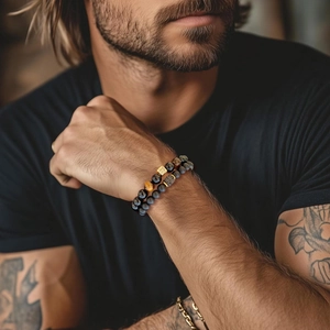 Close-up of men's beaded bracelet set featuring tiger eye and matte onyx stones