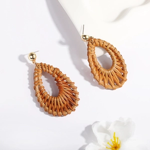 Bohemian teardrop woven rattan drop earrings with gold ball studs on white background