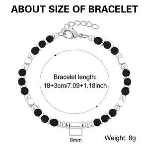 Detail view of natural stone bead bracelet with silver charms and lobster clasp closure