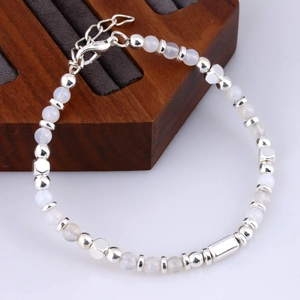 Detail of beaded bracelet with white stones and adjustable silver lobster clasp