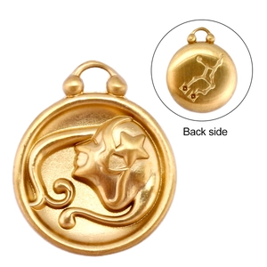 Macro view of golden Virgo zodiac pendant showing embossed front and constellation back side