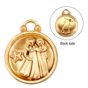 Macro detail of 18k gold Gemini zodiac pendant showing embossed front and back side design