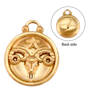 Macro detail of Aries zodiac pendant with gold finish and starry sky pattern back