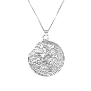 Macro detail of silver stainless steel Sagittarius constellation pendant with vintage texture