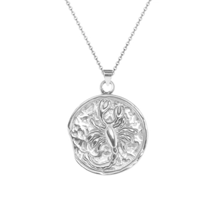 Detailed macro view of silver Scorpio zodiac coin pendant necklace on plain white background