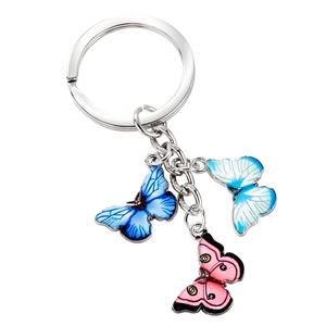Silver metal keychain with blue and pink butterfly pendants on a clean white background